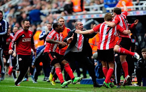 Sunderland manager Paolo Di Canio (c) celebrates with the team after the third Sunderland goal during the Barclays Premier League match between Newcastle United and Sunderland at St James' Park on April 14, 2013 in Newcastle upon Tyne, England. (Photo by Stu Forster/Getty Images)